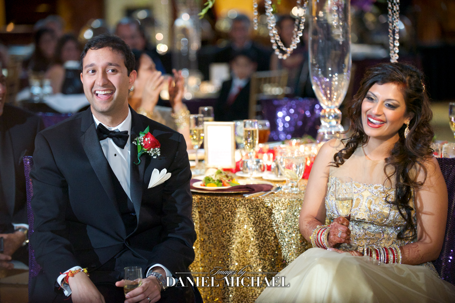 South Asian wedding reception scene with a photographer capturing spontaneous moments